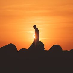 person standing on rock platform